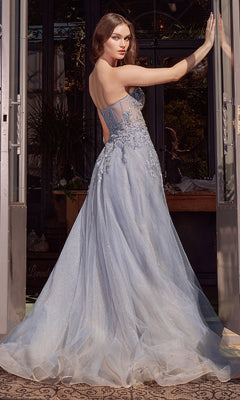 A woman in the strapless Andrea & Leo A1415 prom ball gown with floral embellishments stands in a doorway, looking over her shoulder.