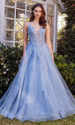 A woman stands outdoors wearing the Embroidered Long Prom Dress: Andrea & Leo A1417, a light blue, floor-length gown with an embroidered bodice and flowing tulle skirt.