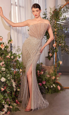 A woman in the Andrea & Leo A1436 Strapless Long Fan Prom Dress poses indoors among flowers and greenery, standing in front of a large mirror.