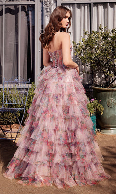 A woman stands outdoors facing away from the camera, wearing the Andrea & Leo A1463 Strapless Print Prom Ball Gown featuring layered ruffles and a floor-length skirt.