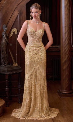 A woman wearing the Andrea & Leo A1526 long prom dress in gold stands indoors near a harp statue and wooden pillars, gazing ahead with her hands in her pockets.