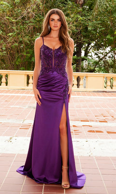 A woman stands outdoors in the Nox Anabel A1585 long beaded-corset prom dress with a fitted silhouette, thigh-high slit, and spaghetti straps, on a tiled patio with greenery in the background.