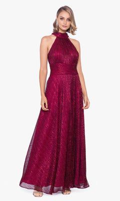 Woman in an Empire-Waist High-Neck Long Shimmer Prom Dress A24948 with a sleeveless, floor-length silhouette and textured burgundy fabric, standing against a plain white background.