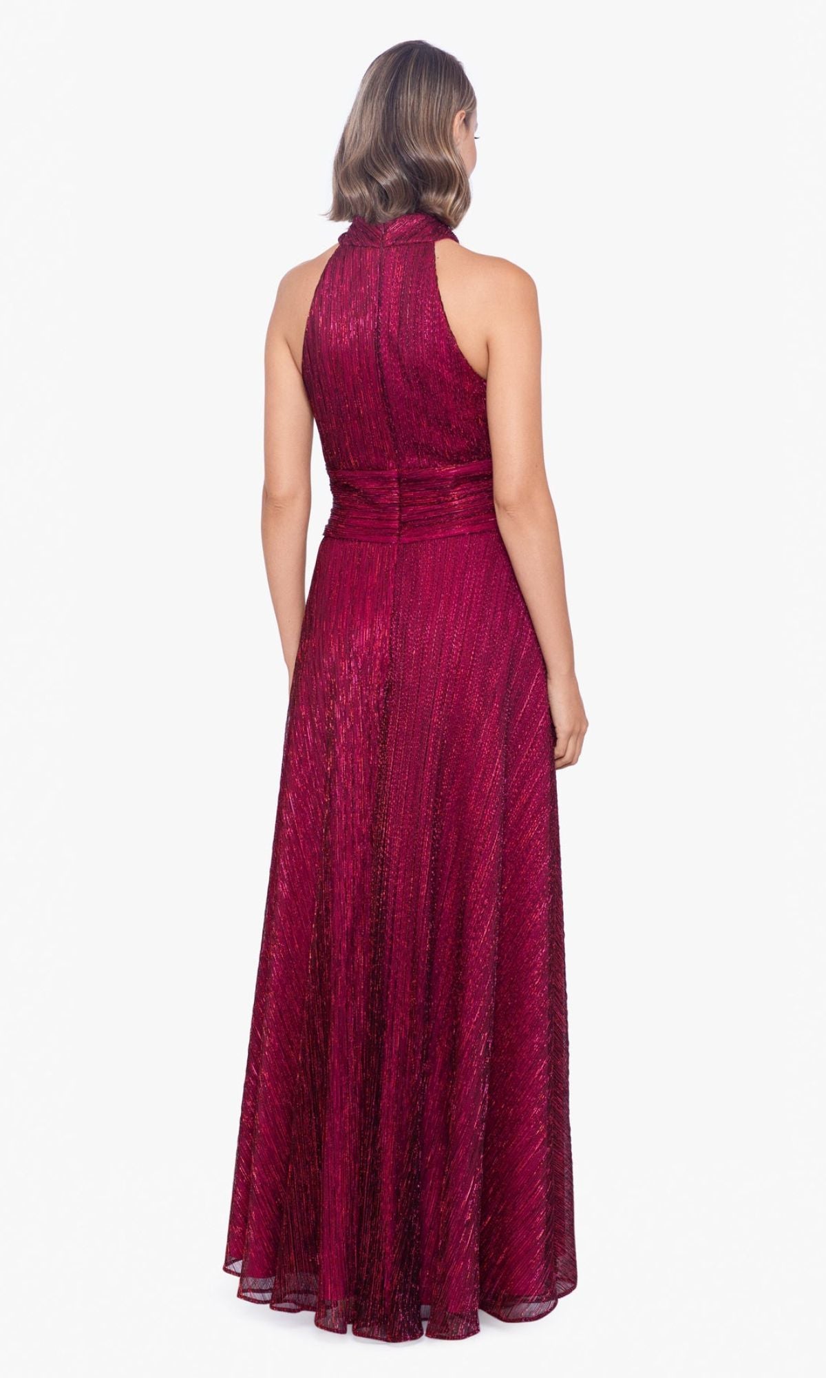 A woman stands facing away, wearing a sleeveless, floor-length Empire-Waist High-Neck Long Shimmer Prom Dress A24948 in dark red against a plain white background.