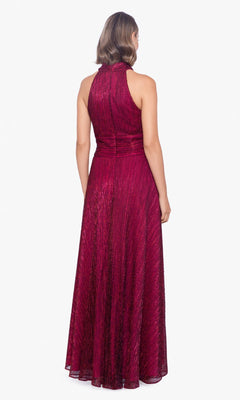 A woman stands facing away, wearing a sleeveless, floor-length Empire-Waist High-Neck Long Shimmer Prom Dress A24948 in dark red against a plain white background.
