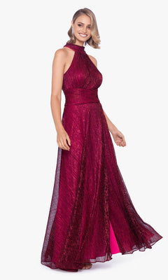 A woman stands smiling in a sleeveless, floor-length Empire-Waist High-Neck Long Shimmer Prom Dress A24948.