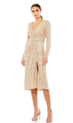 A woman wears the Mac Duggal 26555 long sleeve sequin party dress featuring a deep V-neck, draped waist, and front slit, paired with nude high-heeled sandals.