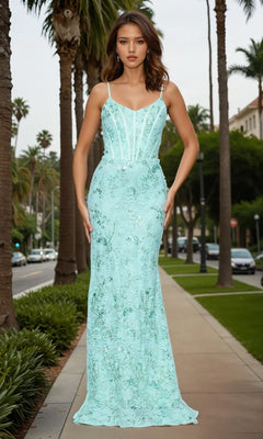 A woman wearing the Betsy and Adam A26885 long formal dress—a fitted, light blue lace gown with thin straps and a corset bodice—stands on a palm tree-lined sidewalk surrounded by greenery.