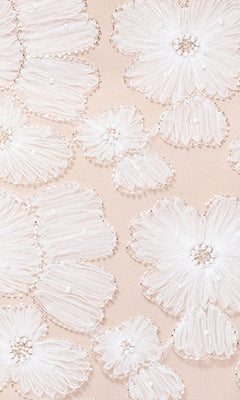 Close-up of white embroidered floral patterns on sheer nude fabric, perfect for the Long Formal Dress: Betsy and Adam A26948, featuring adjustable shoulder straps.