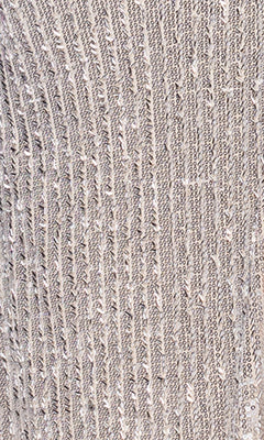 Close-up of textured, ribbed silver fabric with vertical lines and a subtle shimmer—elegant details featured in the Betsy & Adam Long Champagne Prom Dress (A26952).