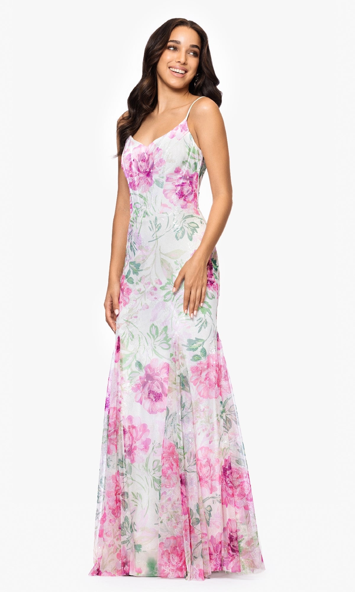 A woman wearing a sleeveless, floor-length Betsy and Adam A27020 long ivory print prom dress stands against a plain white background.