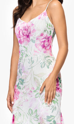 Woman wearing the Long Ivory Print Prom Dress by Betsy and Adam (style A27020); her hand rests by her side.