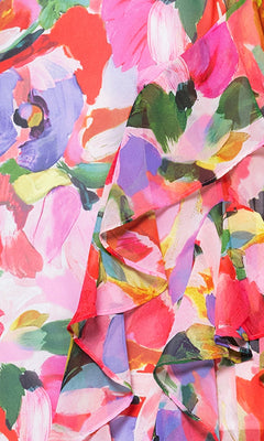 Close-up of the Betsy & Adam A27022 Floral Wedding Guest Dress, featuring watercolor-inspired pink, red, green, and blue brushstrokes with elegant ruffle detailing—an ideal choice for formal events.