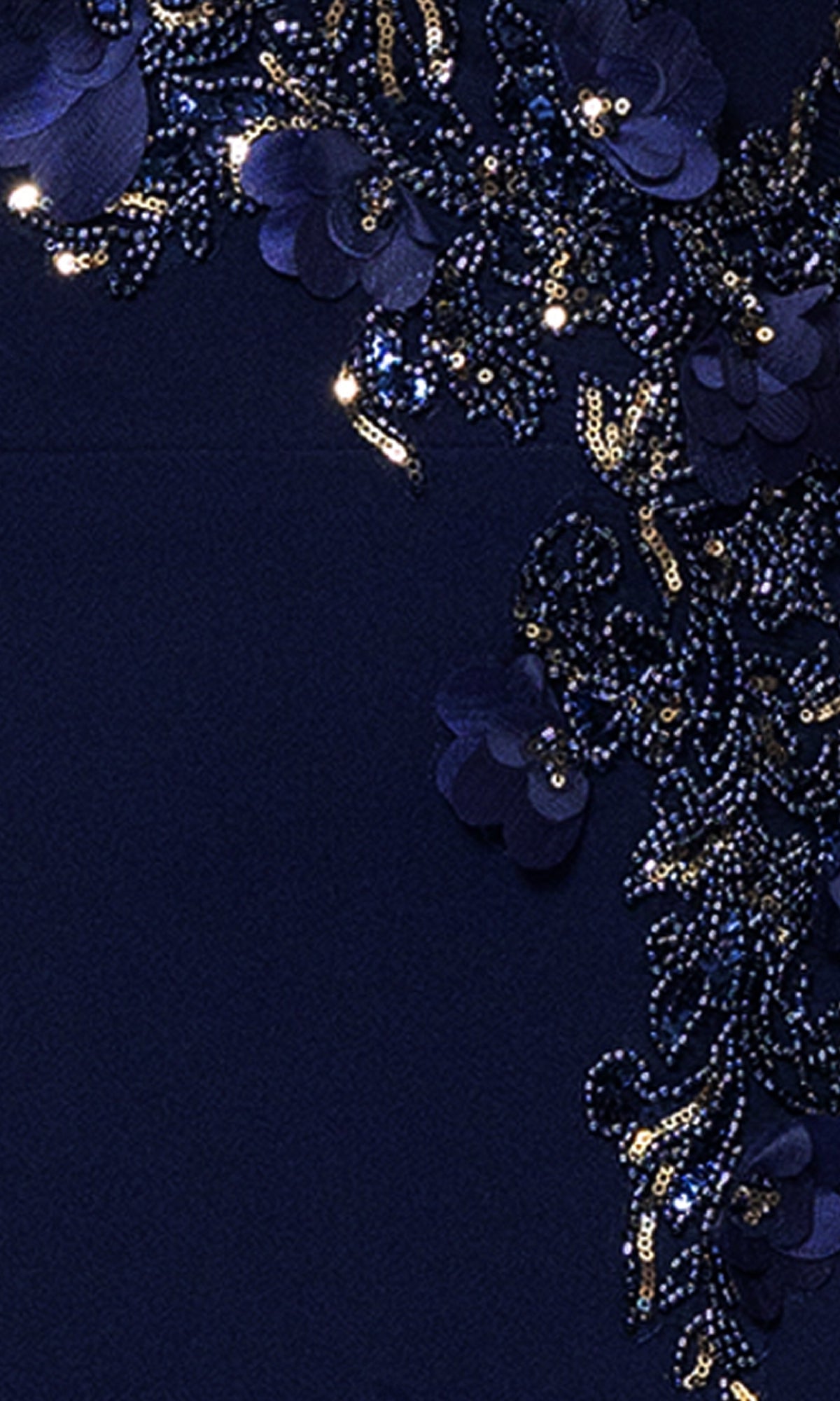 Close-up of the Betsy and Adam A27030 Long Formal Dress, showcasing a navy blue beaded bodice with intricate beadwork, sequins, and floral appliqués in a decorative pattern.