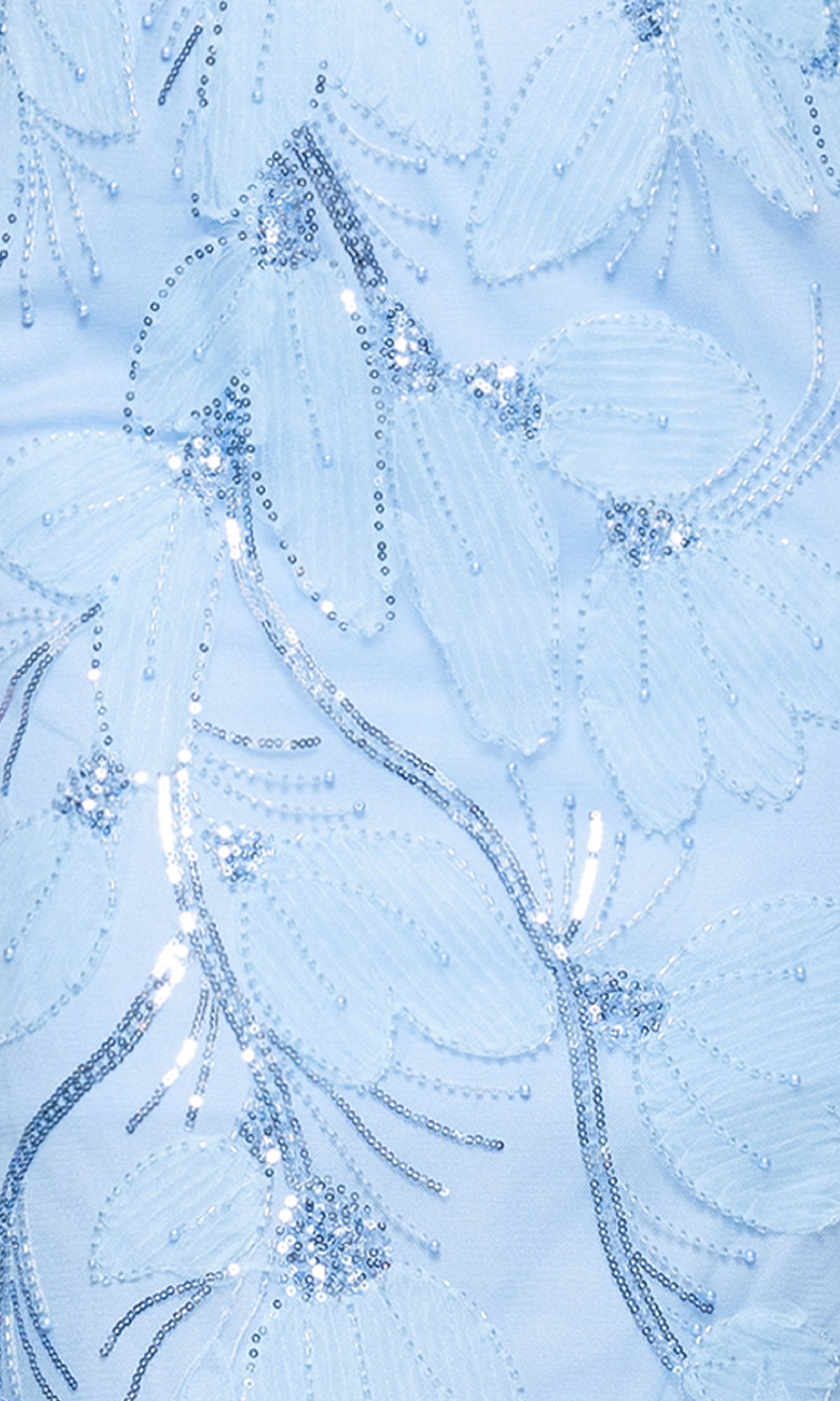 Close-up of the Betsy and Adam A27097 long formal dress in light blue, adorned with floral patterns and silver sequin embellishments for a shimmering effect.