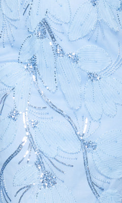 Close-up of the Betsy and Adam A27097 long formal dress in light blue, adorned with floral patterns and silver sequin embellishments for a shimmering effect.