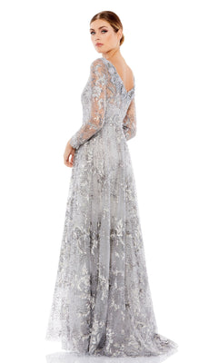 A woman stands gracefully, looking over her shoulder in the Mac Duggal 67498 Long Sleeve Long Formal Dress featuring silver lace details and a v-shaped back.