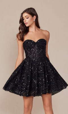 A woman stands against a beige background in the Nox Anabel A843 Sequin Corset Homecoming Dress—strapless, black, with a sequin bodice and flared skirt.