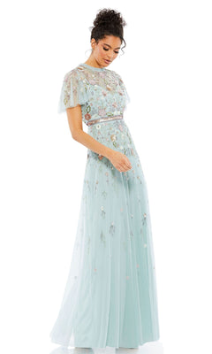 A woman wearing the Long Formal Dress 9136 by Mac Duggal—a light blue beaded A-line gown with floral embroidery, short sheer sleeves, and a sheer sweetheart neckline—stands against a white background.