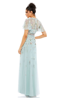 A woman faces away, wearing the Long Formal Dress 9136 by Mac Duggal—a light blue beaded A-line gown with short sheer sleeves and delicate floral embroidery.