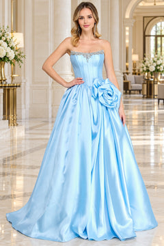 Amelia Couture AL1401 is a light blue strapless corset prom ball gown featuring a beaded sweetheart neckline and a large floral accent at the waist.
