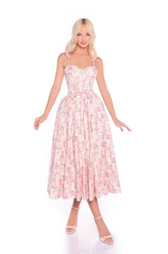 A woman wears the Midi Fit-and-Flare Pink Floral Summer Dress: Aloura with white heels, standing against a white background.