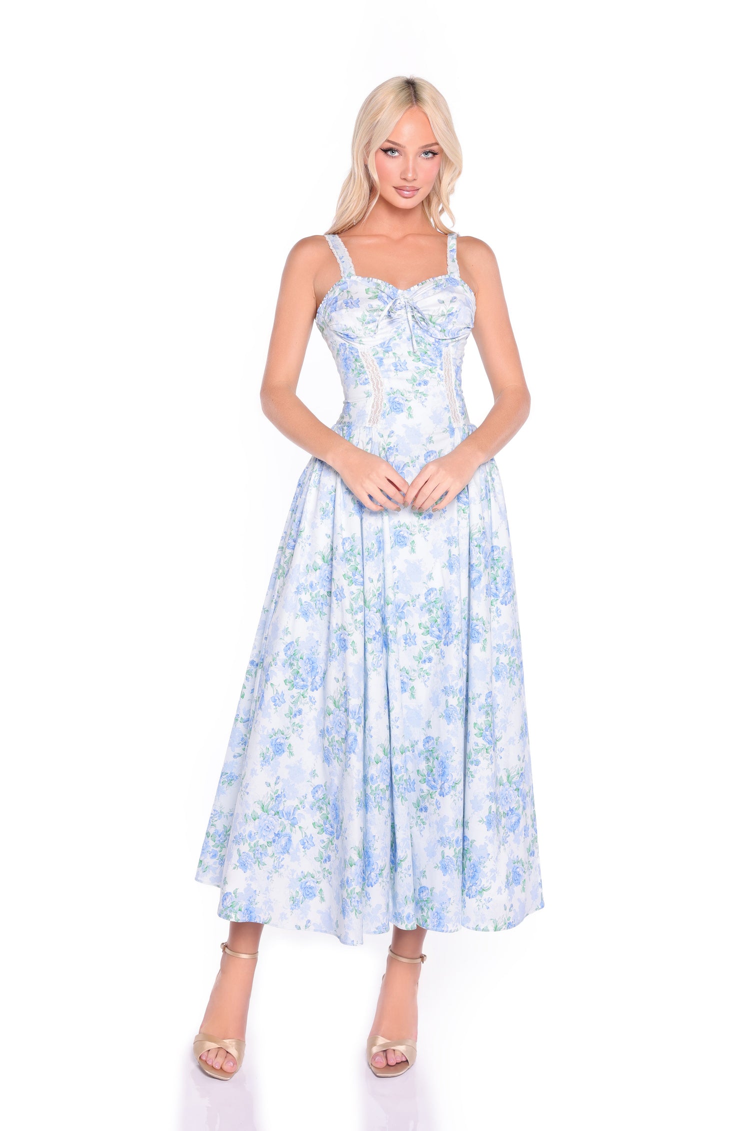 A woman models the Anselma Blue Floral Cotton Summer Midi Dress, featuring a fitted bodice and flared skirt—an ideal fit-and-flare choice for summer events—posed against a plain white background.