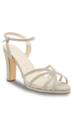 The Anya Champagne Glitter Prom Shoes by Touch Ups 4668 are beige high-heeled sandals with an ankle strap, open toe, crisscross front straps, and a shimmery textured finish—ideal for your next special occasion.