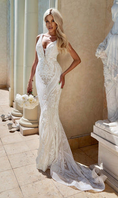Woman wearing the Tina Holly BA109 White Lace Mermaid Wedding Gown holds white roses beside a white statue and columns.