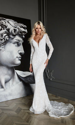 A woman in the Tina Holly BB023 long formal dress stands beside a large black and white painting of Michelangelo's David.