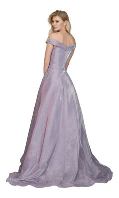 A woman stands gracefully, looking over her shoulder in the Off-Shoulder Long A-Line Prom Dress: Chicas BT9017—a floor-length lavender gown with a fitted bodice and flowing skirt.