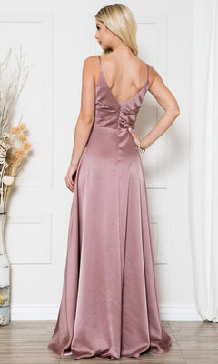 A woman stands indoors facing away, wearing the Long Satin A-Line Formal Prom Dress BZ012 in mauve with a sleeveless design and deep V-back. Dried floral decor appears on the left.