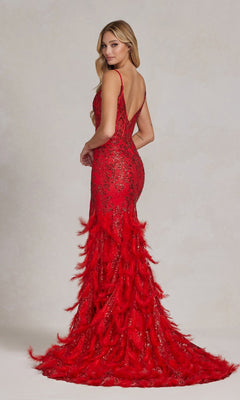 A woman wears the Open-Back Shimmer Prom Dress with a fitted, floor-length silhouette, feather skirt, sequin detailing, and sheer corset accents, standing slightly turned away from the camera against a neutral background.