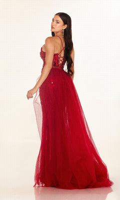 Woman in the Cecilia Couture C132 long red lace gown, featuring a fitted bodice and lace-up back, stands looking over her shoulder against a plain background. Sparkling details make this dress ideal for special evenings or as a prom dress.