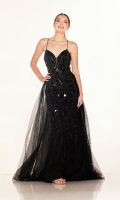 A woman stands against a white background wearing the Cecilia Couture C132, a floor-length black sequin prom dress featuring thin straps and a chic lace-up back.