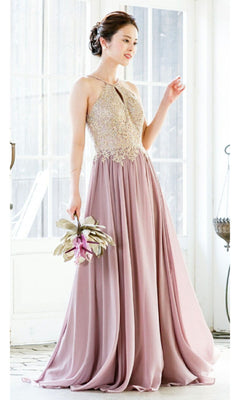A woman indoors holds a bouquet, wearing the Chicas C1521 High-Neck Long A-Line Prom Dress—sleeveless, floor-length, in mauve with an embellished bodice and golden lace embroidery.