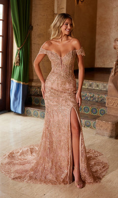 A woman stands elegantly indoors by a staircase, wearing the Nox Anabel C1600 Lace-Up Long Beaded Prom Dress in blush, featuring an off-the-shoulder neckline, thigh-high slit, and a sweeping train.