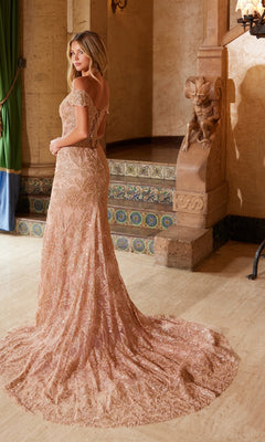 A woman stands indoors near ornate stonework and tiled steps, facing away, wearing the Nox Anabel C1600 Lace-Up Long Beaded Prom Dress with a train.