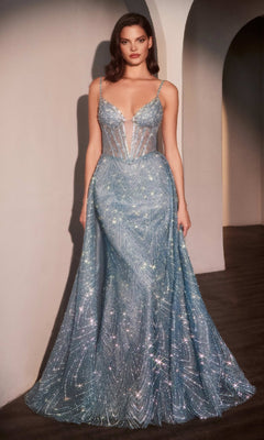 A woman poses against a neutral background, wearing the Ladivine C167 Deep V-Neck Long Glitter Prom Dress—a shimmering light blue formal gown with thin straps, a sheer beaded bodice, mermaid skirt, and intricate sparkling patterns.
