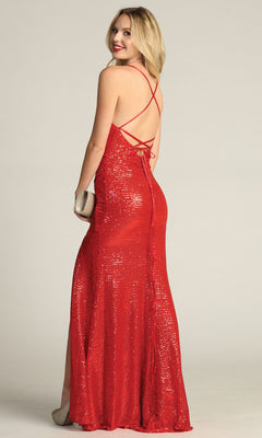 A woman in the Lace-Up Long Sequin Prom Dress: Chicas C2402, featuring crisscross straps and an open back, stands holding a small clutch and looks over her shoulder.