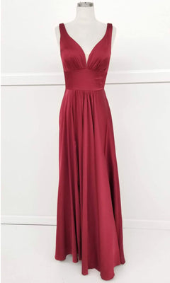 The Chicas C242 Empire-Waist Long A-Line Prom Dress features a sleeveless, floor-length burgundy design with a deep V-neckline and fitted waist—a sophisticated choice for any formal event.