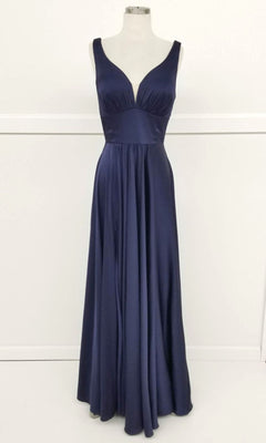 The Empire-Waist Long A-Line Prom Dress: Chicas C242, a sleeveless navy blue satin evening gown with a deep V-neckline, is displayed on a dress form against a white background.