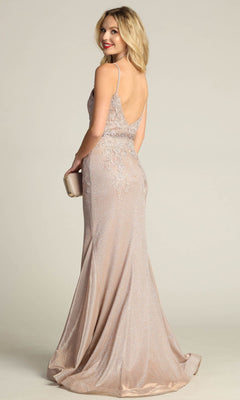 A woman in the Chicas C243 Low-Back Long Mermaid Prom Dress poses against a plain background, showcasing its floor-length silhouette, thin straps, and elegant low-back design while holding a clutch.