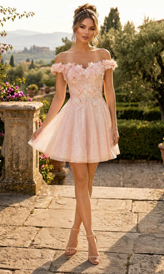A woman stands outdoors on a stone walkway surrounded by greenery wearing the Chicas C312 Short Homecoming Dress in blush, featuring an off-the-shoulder fit-and-flare silhouette with 3D floral appliques and paired with heels.