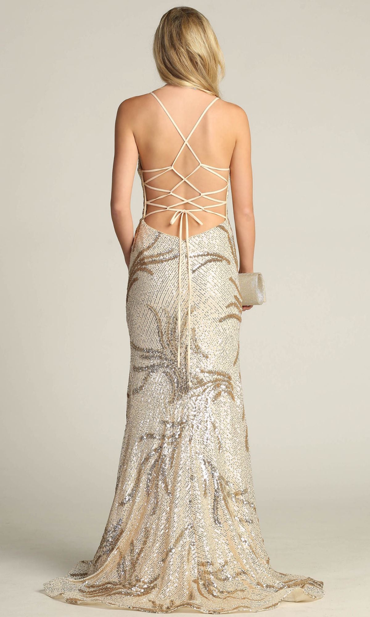 A woman in the Lace-Up Long Sequin Prom Dress: Chicas C316, featuring a backless, floor-length design with crisscross straps, holds a clutch and stands facing away from the camera.
