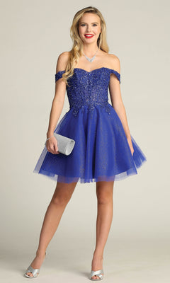 A woman in the Off-Shoulder Short Glitter Homecoming Dress C318, paired with a silver clutch and silver peep-toe heels, poses against a neutral background.
