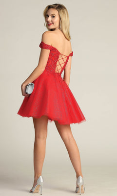 A woman in the Off-Shoulder Short Glitter Homecoming Dress C318 poses with a silver clutch and heels, smiling over her shoulder against a plain background.