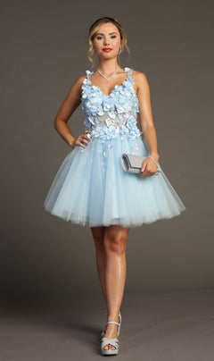 A woman in the Floral-Bodice Short Babydoll Homecoming Dress C321, featuring a light blue floral bodice, pairs it with silver heels and a matching clutch, standing against a plain gray background.