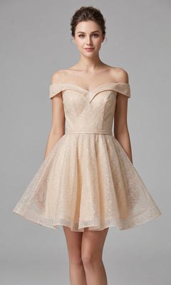A woman stands against a plain gray background wearing the Chicas C323 short homecoming dress in champagne. The light, off-the-shoulder design features a fitted bodice and flared skirt in an A-line silhouette, accentuating her figure with effortless elegance.