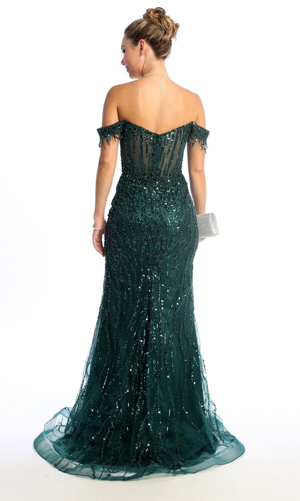 A woman in the Off-Shoulder Long Sequin Prom Dress: Chicas C331 in dark green holds a silver clutch, standing against a white background and facing away from the camera.